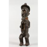 A LARGE CARVED TRIBAL MALE FIGURE. 16ins long.