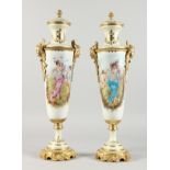 A PAIR OF TALL, SLENDER SEVRES STYLE PORCELAIN VASES with ormolu mounts. 21ins high.