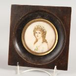 A CIRCULAR PORTRAIT MINIATURE OF A YOUNG LADY in a wooden frame. 2.25ins. Signed.