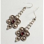 A PAIR OF SILVER AND GARNET EARRINGS.