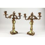 A GOOD PAIR OF 19TH CENTURY FRENCH ORMOLU AND GREEN PORCELAIN TWO-LIGHT CANDLESTICKS. 13ins high.