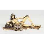 A VIENNA STYLE COLD PAINTED BRONZE OF A FEMALE NUDE ON A TIGER'S SKIN RUG. 6ins long.