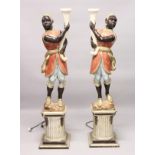 A PAIR OF PAINTED, CARVED AND BLACKAMOOR FLOOR STANDING NINE LIGHT CANDELABRA. 6ft 4ins high.