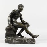 AFTER THE ANTIQUE A BRONZE OF MERCURY sitting on a rock. 11.5ins high.