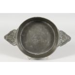 AN EARLY PEWTER CIRCULAR TWO-HANDLED QUAICH. 6.5ins diameter. stamped A. POULLYON.