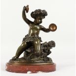 AFTER CLODION (1738-1814) FRENCH A GOOD BRONZE OF A SEATED CUPID playing cymbals, on a circular