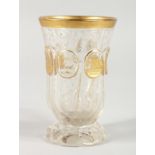 A BOHEMIAN GILDED GLASS BEAKER. 4.75ins high.