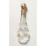 A CUT GLASS SCENT BOTTLE with an 18ct gold top.