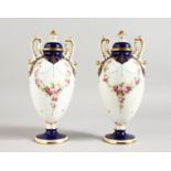 AN EARLY 20TH CENTURY MINTON PAIR OF TWO-HANDLED PEDESTAL OVOID VASES painted by Dudley, signed,