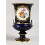 A GOOD 19TH CENTURY MEISSEN RICH BLUE URN SHAPED VASE, painted with a panel of flowers. Cross swords