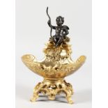 A GILT BRONZE TABLE SALT modelled as a cherub seated on a shell. 7.5ins high.