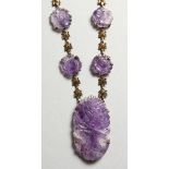 A 14CT GOLD AND AMETHYST NECKLACE.