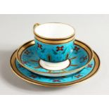 A SUPERB MINTON COFFEE CUP, SAUCER AND SIDE PLATE painted in the style of Sir Christopher Dresser.
