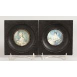 A PAIR OF CIRCULAR PORTRAIT MINIATURES OF YOUNG LADIES in wooden frames. 2.25ins diameter.