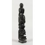 A MINIATURE CARVED STONE TOTEM POLE. 8ins high.