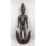 A LARGE CARVED WOOD STANDING MALE FIGURE. 42ins long.