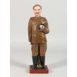 A RUSSIAN POTTERY STANDING FIGURE, holding a pipe. 13ins high.