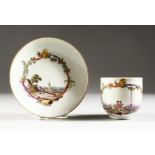 AN IMPORTANT MEISSEN CUP AND SAUCER, the cup painted with a group of merchants at a quayside, the