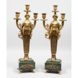 A PAIR OF GILT BRONZE EMPIRE STYLE FIGURAL CANDELABRA, on marble bases.
