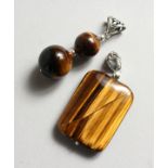 TWO SILVER AND TIGER'S EYE PENDANTS.