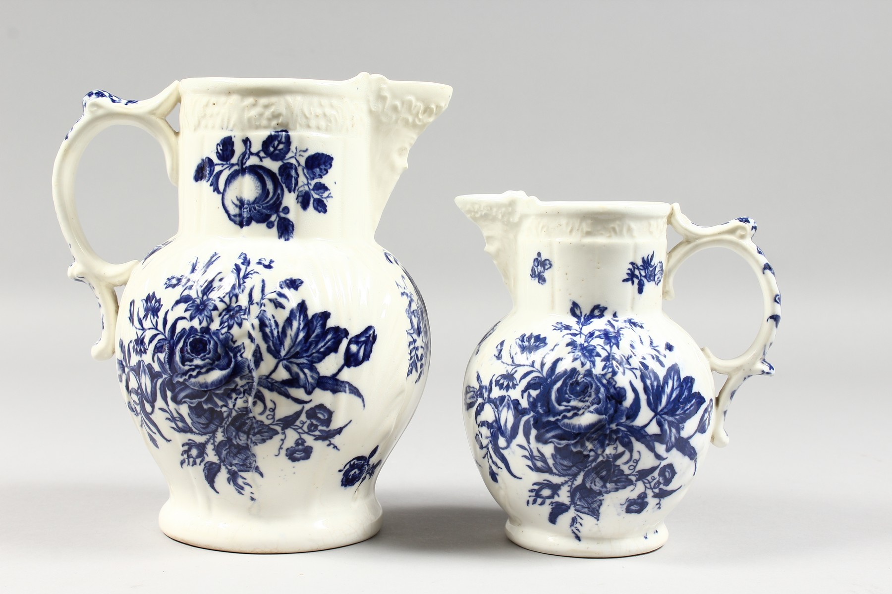 A GRADUATED PAIR OF DECORATIVE ENGLISH PORCELAIN MASK JUGS printed with fir cones and roses in - Image 2 of 9