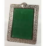 A GOOD UPRIGHT PHOTOGRAPH FRAME with floral borders. 14ins x 10ins.