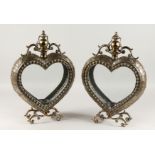 A GOOD PAIR OF GILDED METAL HEART SHAPED LANTERNS on curving feet. 22ins high.