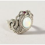 A SILVER, OPAL AND RUBY EYE SNAKE RING.