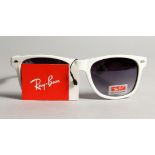 A PAIR OF NEW RAYBAN SUN GLASSES.