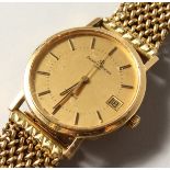 A GENTLEMAN'S 18CT GOLD BAUME MERCIER WRISTWATCH AND BRACELET. No. 1074677 73225.