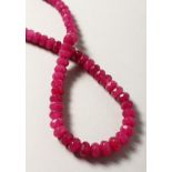 A STRING OF RUBY BEADS.