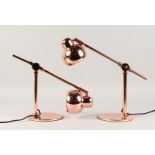 A PAIR OF COPPER ANGLE POISE LAMPS.