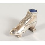 A CAST SILVER ROLLER SKATE PIN CUSHION.