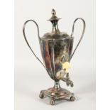 A GEORGE III TWO HANDLED TEA URN AND COVER with reeded handles and pineapple finial, square shaped