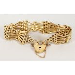 AN 18CT GOLD GATE BRACELET WITH PADLOCK.