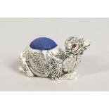 A SILVER PLATE CAMEL PIN CUSHION.