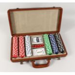 A LEATHER POKER SET in a fitted case with counters, cards and dice. 165ins long.