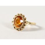 A 9CT GOLD TOPAZ RING.