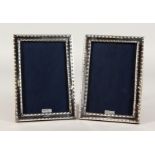 A PAIR OF SILVER PHOTOGRAPH FRAMES with bead edge. 7ins x 5ins.