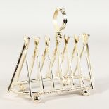 A SILVER PLATE CRICKET SIX-DIVISION TOAST RACK, with cross bats and stumps.