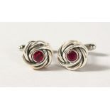 A PAIR OF SILVER AND RUBY KNOT CUFFLINKS.