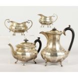 A GEORGE V SILVER FOUR-PIECE TEA SET, comprising teapot, hot water jug, sugar basin and milk jug.