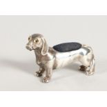 A CAST SILVER DACHSHUND PIN CUSHION.