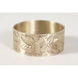 A BRIGHT CUT SILVER BANGLE.