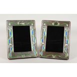 A PAIR OF SILVER AND COLOURED ENAMEL PHOTOGRAPH FRAMES, Art Nouveau design. 7.5ins x 5.75ins.