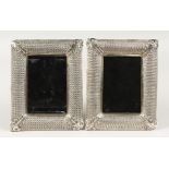 A PAIR OF METAL UPRIGHT PHOTOGRAPH FRAMES with pierced borders. 8ins x 6ins.
