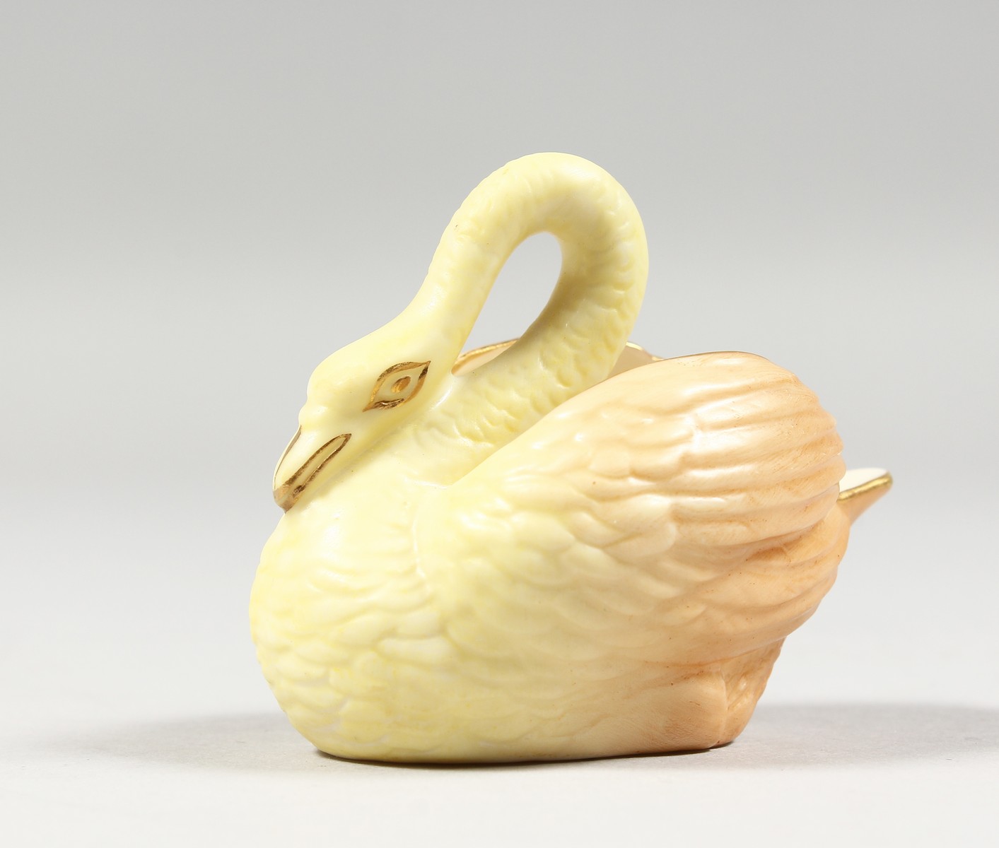 A ROYAL WORCESTER RARE BLUSH IVORY MINIATURE MODEL OF A SWAN, date code 1903.