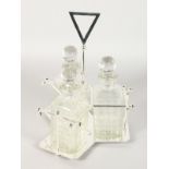 A SILVER PLATE STAND with three cut glass whisky decanters and stoppers.
