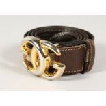 A BROWN LEATHER AND FABRIC GUCCI BELT with gilt GG.