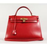 A VERY GOOD HERMES RED LEATHER HANDBAG with brass lock. No. 124. 13ins long x 10ins high, with short